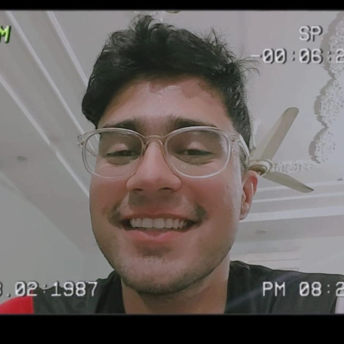 Saaim smiling in glasses