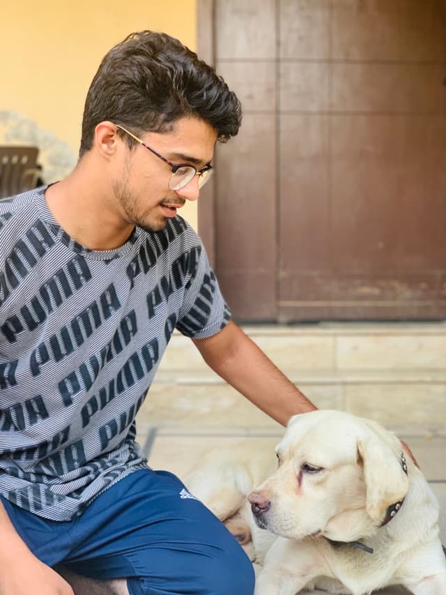 Saaim relaxing with a dog